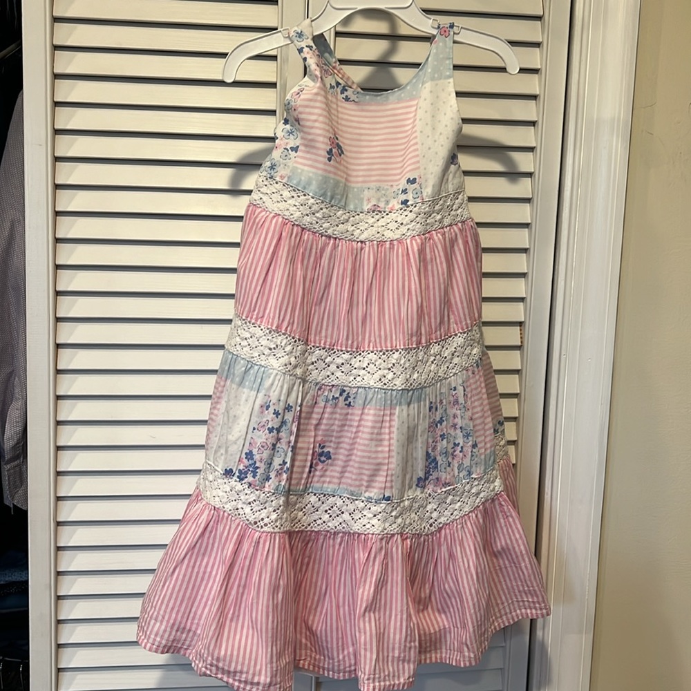 A flower dress with stripes. Size (7). Used, but still in good condition.